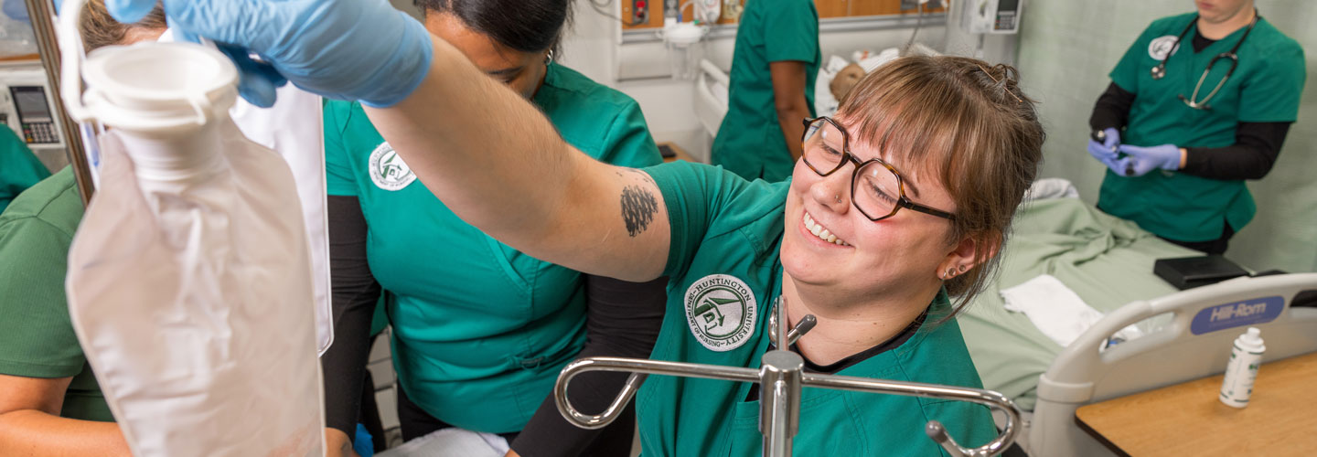 Student hanging an IV bag