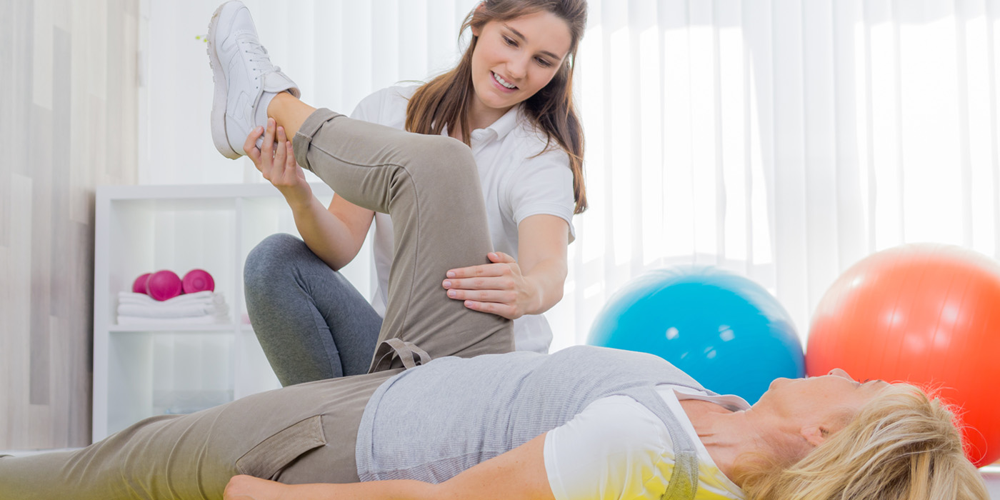 Physical therapy aid working with a patient