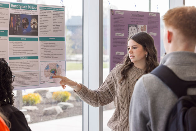 Pharmacology student presenting a poster