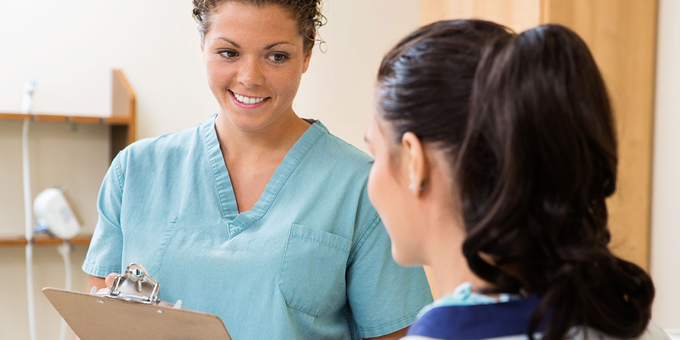 Medical assistant talking to a pacient